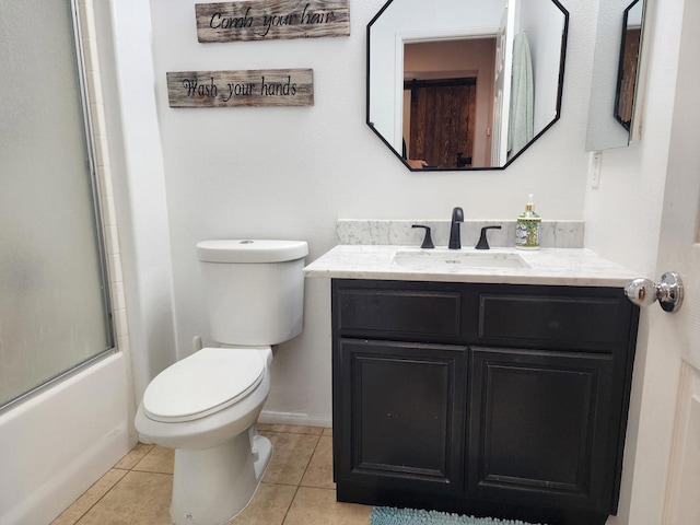 full bathroom featuring combined bath / shower with glass door, vanity, toilet, and tile patterned floors