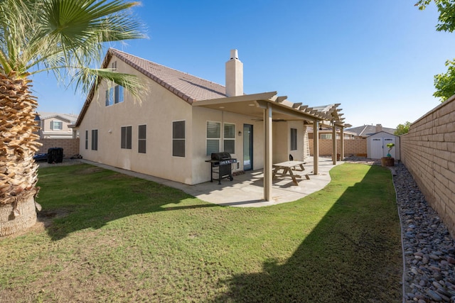 back of house with a patio, a shed, and a yard