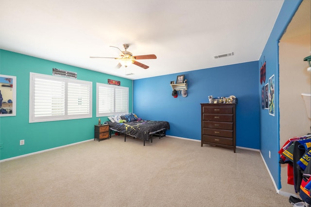 bedroom with ceiling fan and light colored carpet