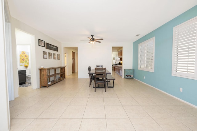 dining area featuring light tile patterned floors and ceiling fan