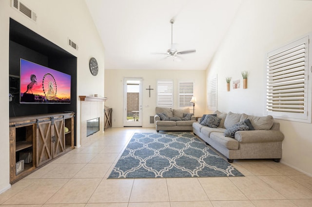 living room featuring light tile patterned floors, ceiling fan, and high vaulted ceiling