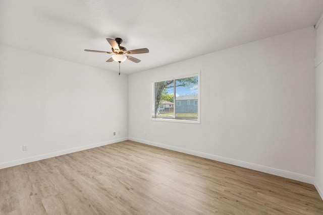 empty room featuring ceiling fan and light hardwood / wood-style floors