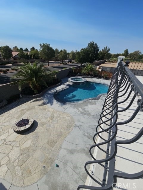 view of swimming pool with a patio and an in ground hot tub