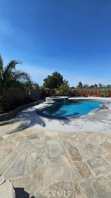 view of pool featuring a pool with connected hot tub