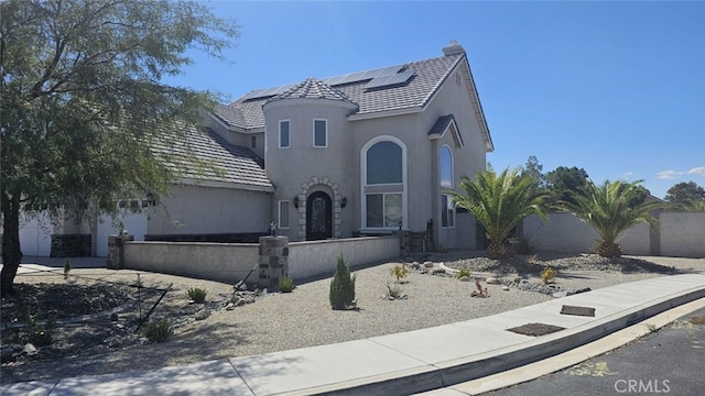 view of front of property featuring solar panels