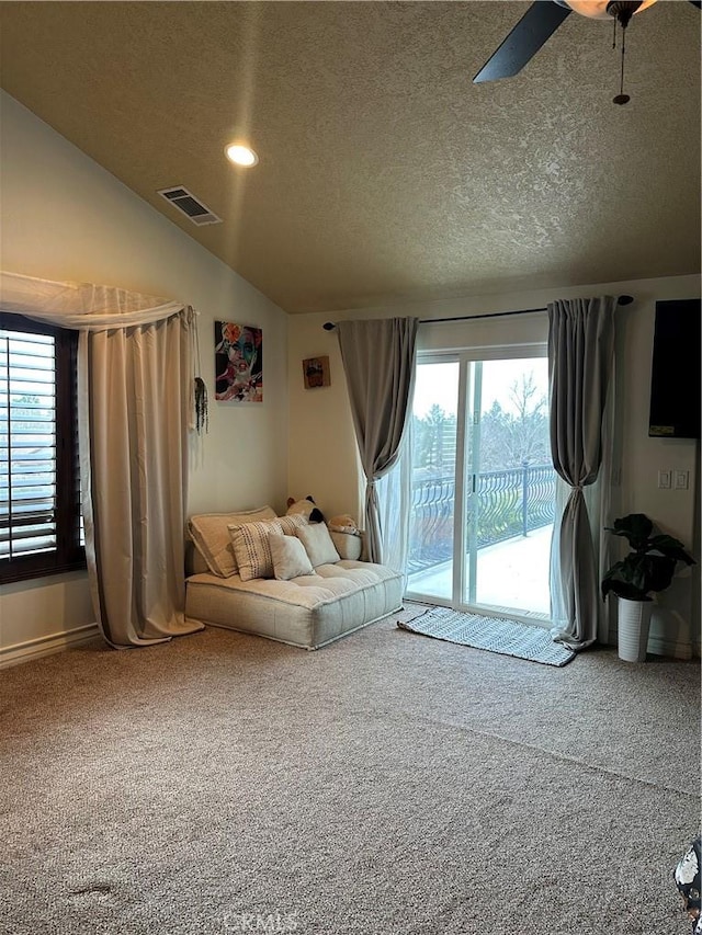 carpeted living room featuring recessed lighting, visible vents, vaulted ceiling, a textured ceiling, and ceiling fan