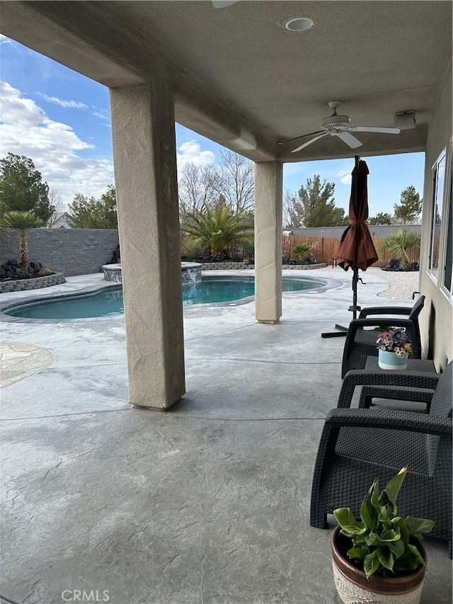 view of patio featuring a fenced backyard, a ceiling fan, and a fenced in pool