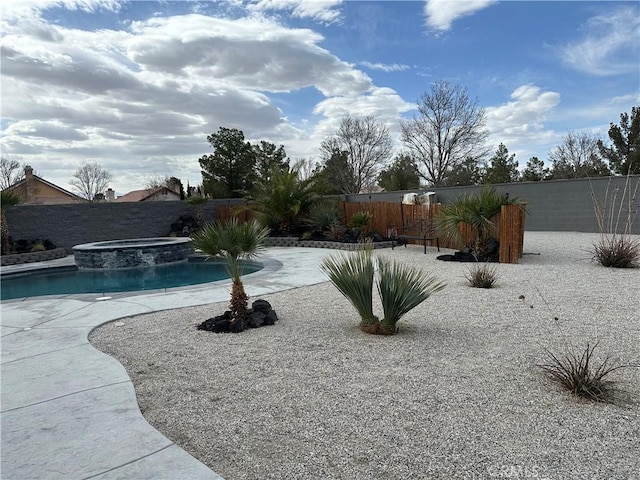 view of swimming pool with a patio area, a fenced backyard, and a pool with connected hot tub