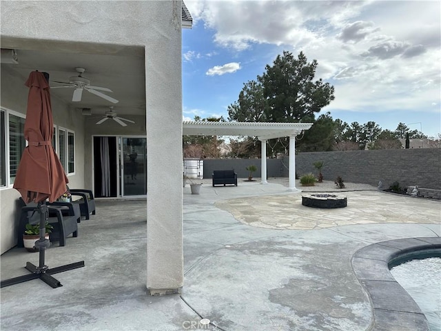 view of patio with a fenced backyard, a fire pit, a pergola, and a ceiling fan