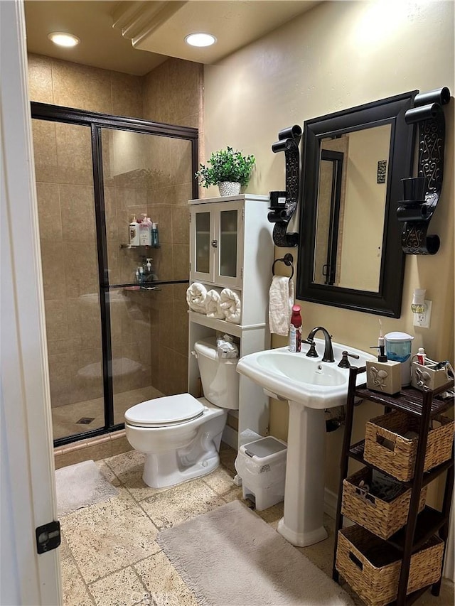 full bath featuring a stall shower, stone tile flooring, toilet, and recessed lighting