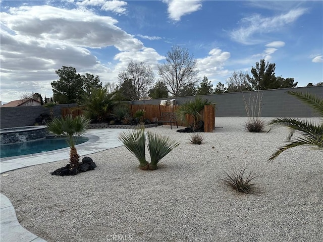 view of yard featuring a fenced backyard, a fenced in pool, and a patio