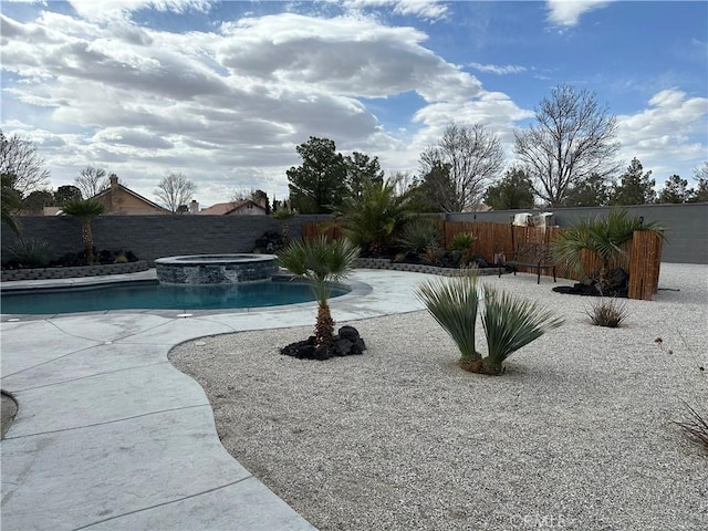 view of pool with a patio area, a fenced backyard, and a pool with connected hot tub