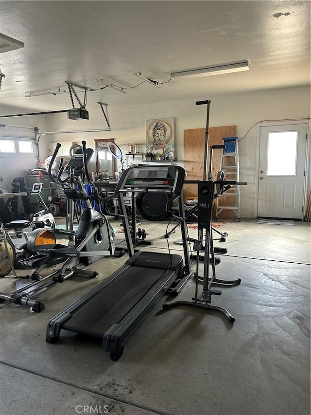 workout area featuring a garage and plenty of natural light