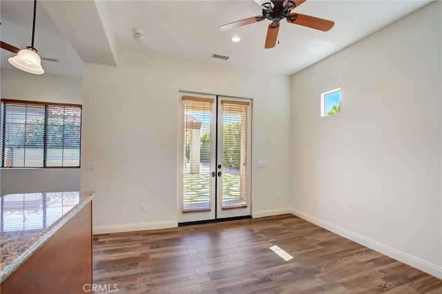 doorway with dark hardwood / wood-style flooring, plenty of natural light, and french doors