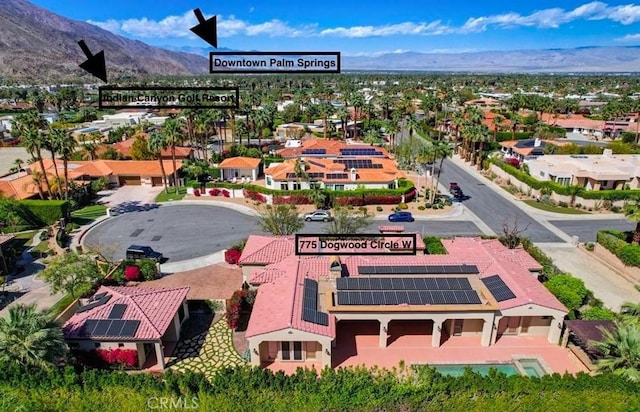 birds eye view of property with a mountain view