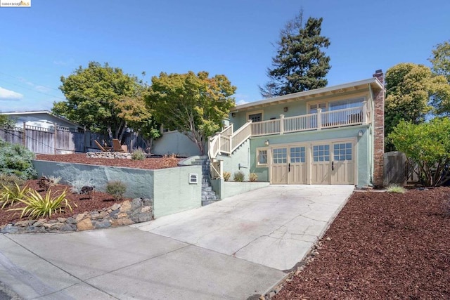 view of front of house featuring a balcony and a garage