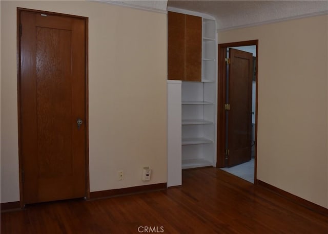 unfurnished bedroom featuring dark hardwood / wood-style floors