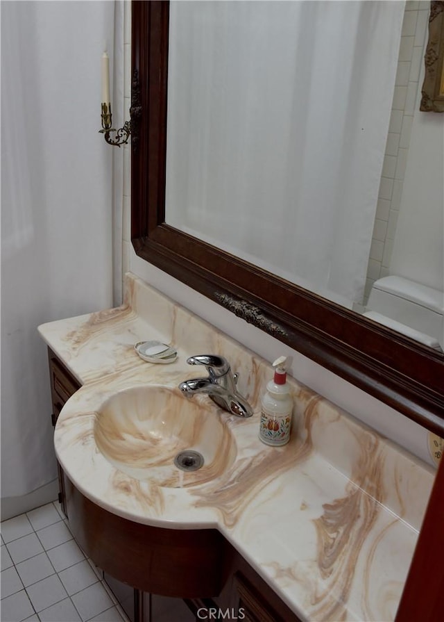 bathroom featuring tile patterned flooring and vanity