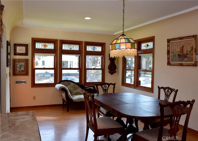 dining area featuring light hardwood / wood-style flooring and ornamental molding