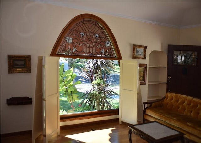 entryway featuring crown molding and hardwood / wood-style flooring