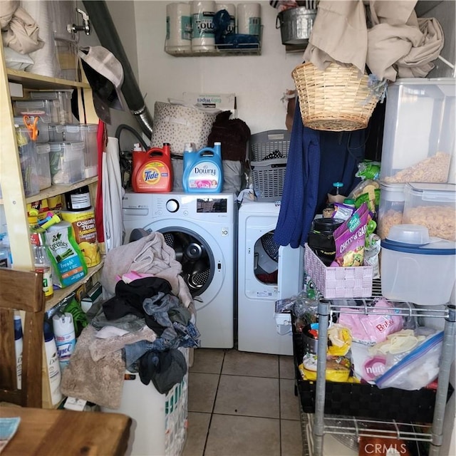 clothes washing area with laundry area, washer and clothes dryer, and tile patterned floors