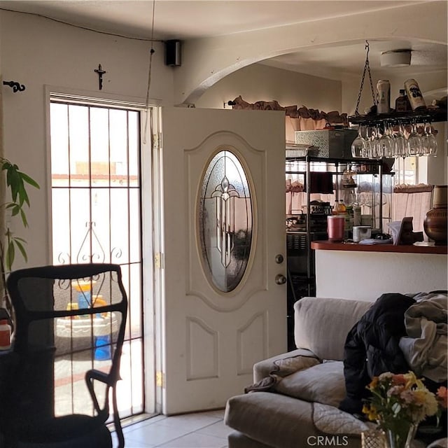 entrance foyer with plenty of natural light and light tile patterned flooring