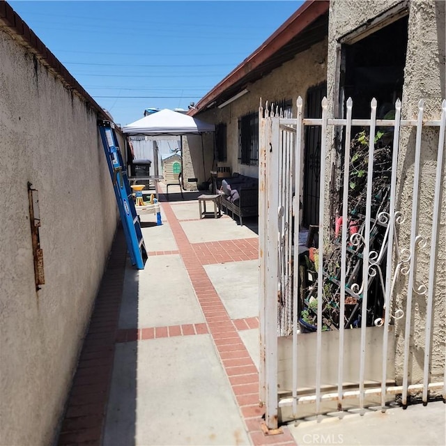 view of patio with fence, an outdoor hangout area, and a gazebo