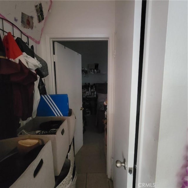 clothes washing area featuring laundry area, tile patterned flooring, and washing machine and dryer