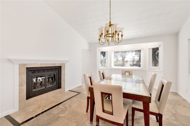 dining room featuring an inviting chandelier and a tile fireplace