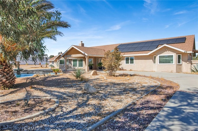 view of front of property featuring solar panels