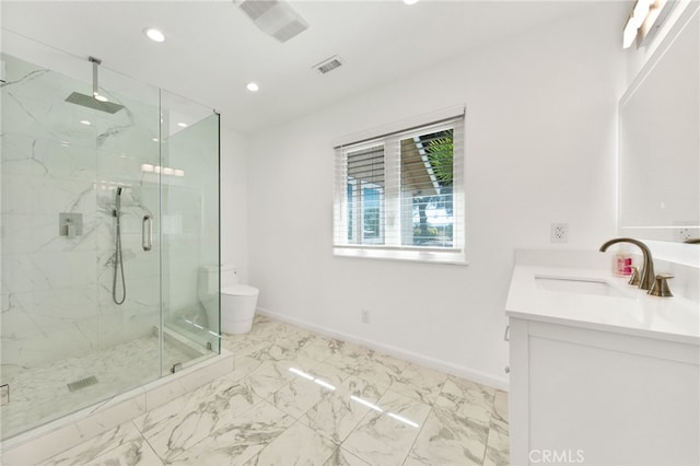 bathroom featuring vanity, toilet, and a shower with door