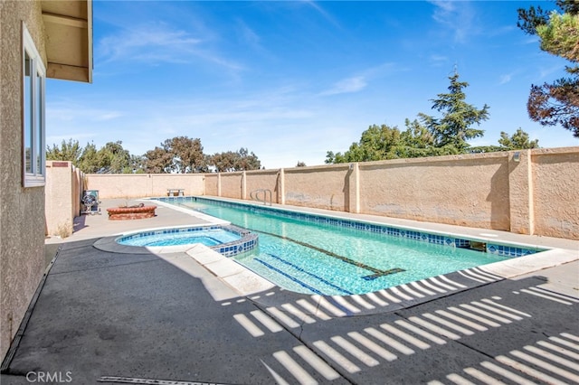 view of pool featuring an in ground hot tub and a patio area