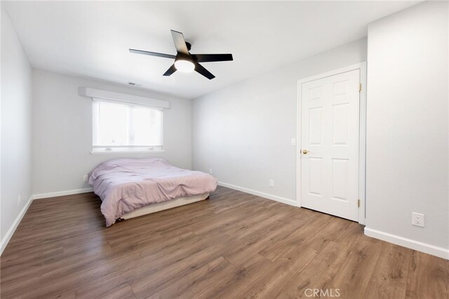 bedroom with wood-type flooring and ceiling fan