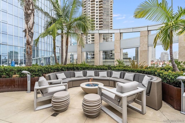 view of patio featuring an outdoor living space with a fire pit