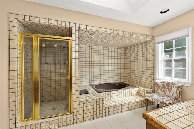 bathroom featuring tile patterned floors and independent shower and bath