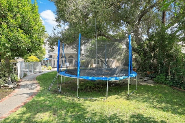 view of play area with a yard and a trampoline