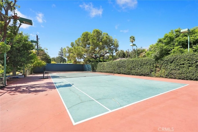 view of sport court with basketball hoop