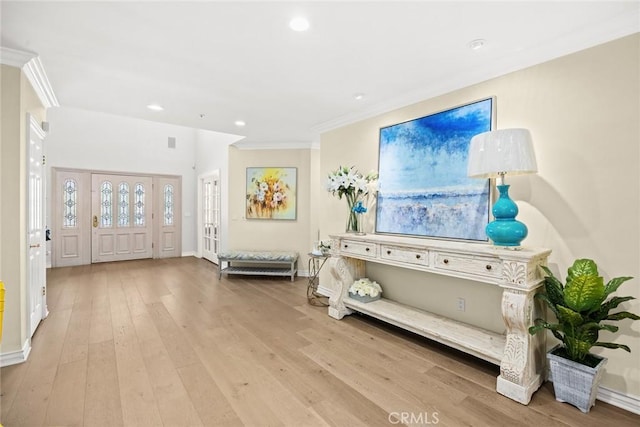 interior space with light hardwood / wood-style flooring and ornamental molding