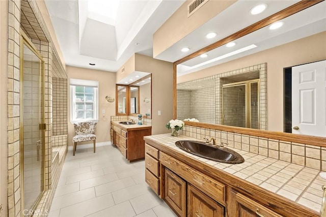 bathroom featuring tile patterned flooring, vanity, and an enclosed shower