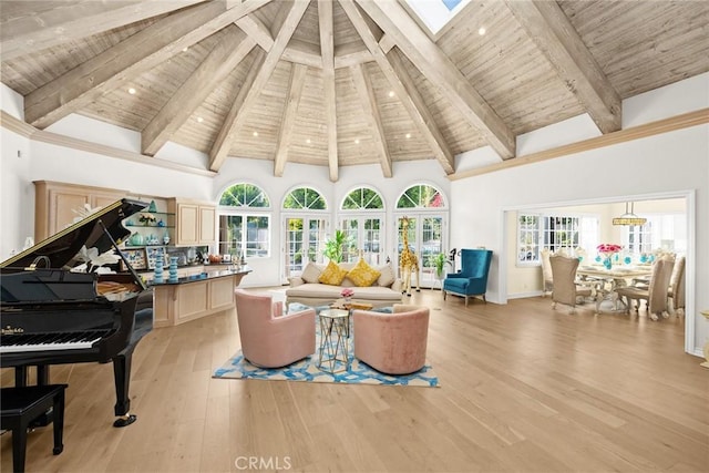 sitting room with beam ceiling, light hardwood / wood-style flooring, high vaulted ceiling, and wood ceiling