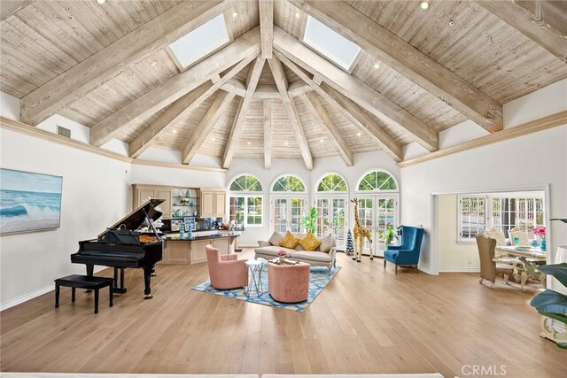 living room with beamed ceiling, high vaulted ceiling, light hardwood / wood-style flooring, and wood ceiling