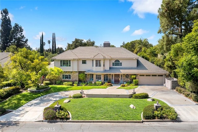 front of property with a front yard and a garage