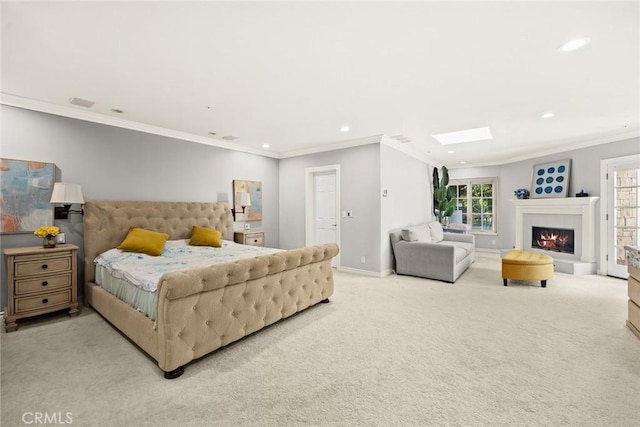 bedroom with ornamental molding, light carpet, and a skylight