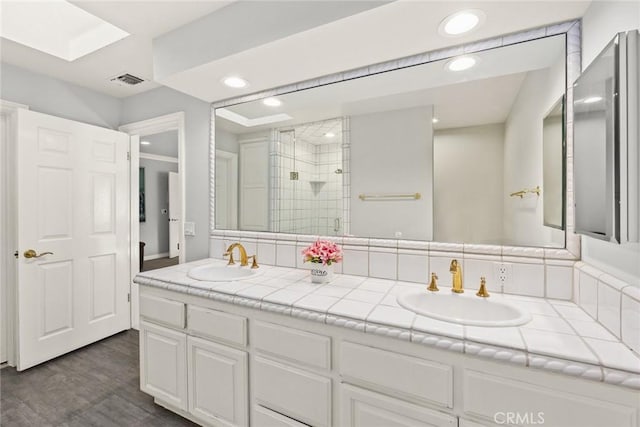 bathroom with vanity and an enclosed shower