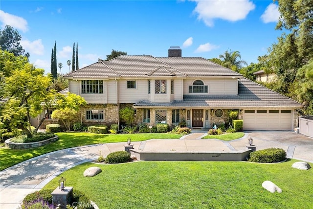 view of front of house with a garage and a front lawn