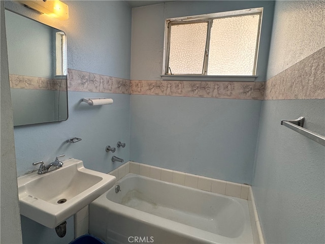 bathroom with a bathing tub and sink