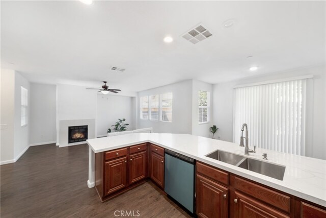 kitchen featuring ceiling fan, sink, kitchen peninsula, dark wood-type flooring, and dishwasher