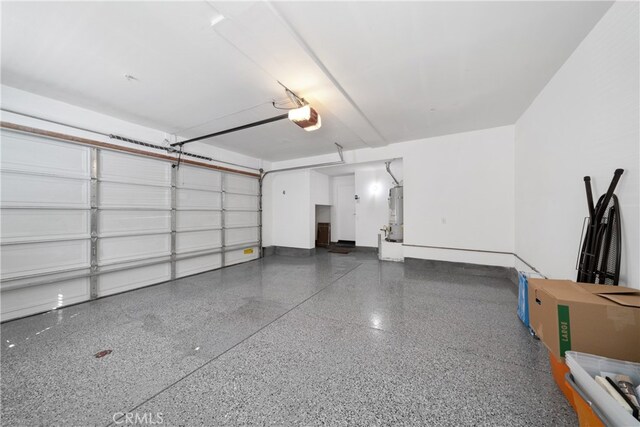 garage featuring a garage door opener and strapped water heater