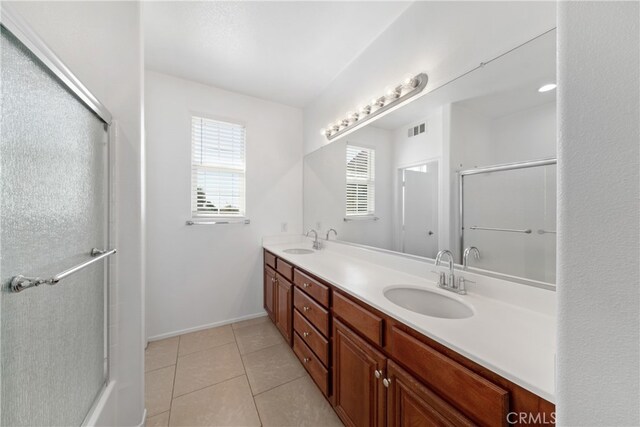 bathroom featuring walk in shower, tile patterned flooring, and vanity