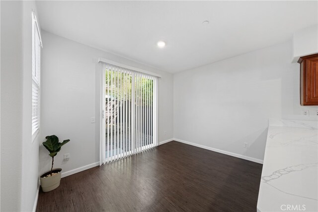 unfurnished room with dark hardwood / wood-style flooring